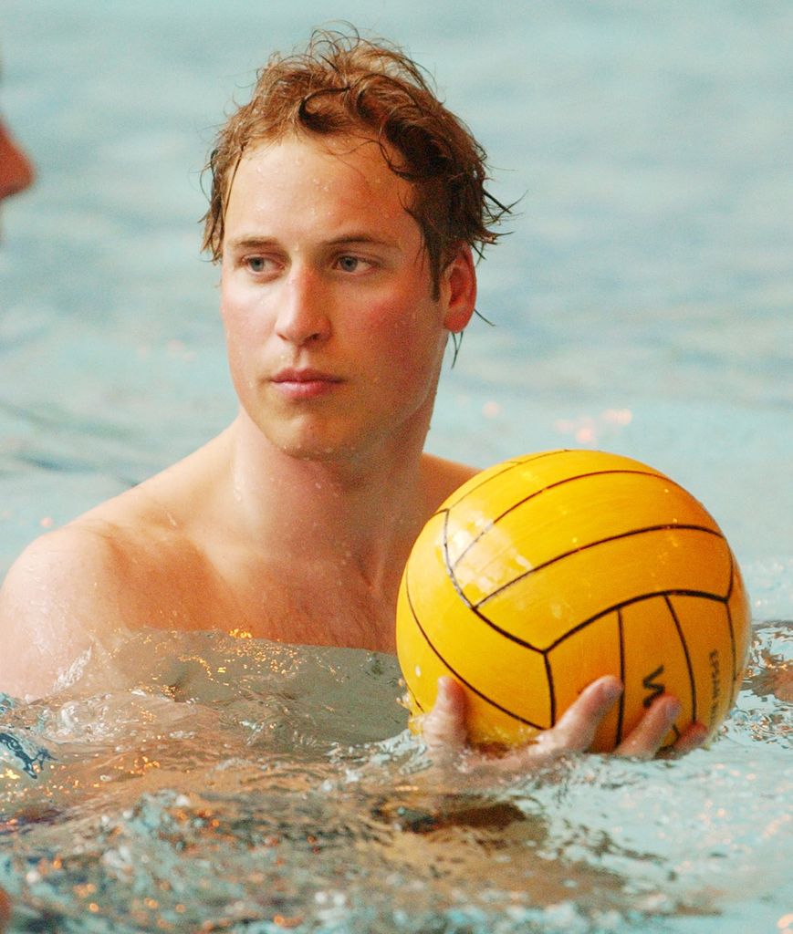 Prince William holding a ball while playing water polo