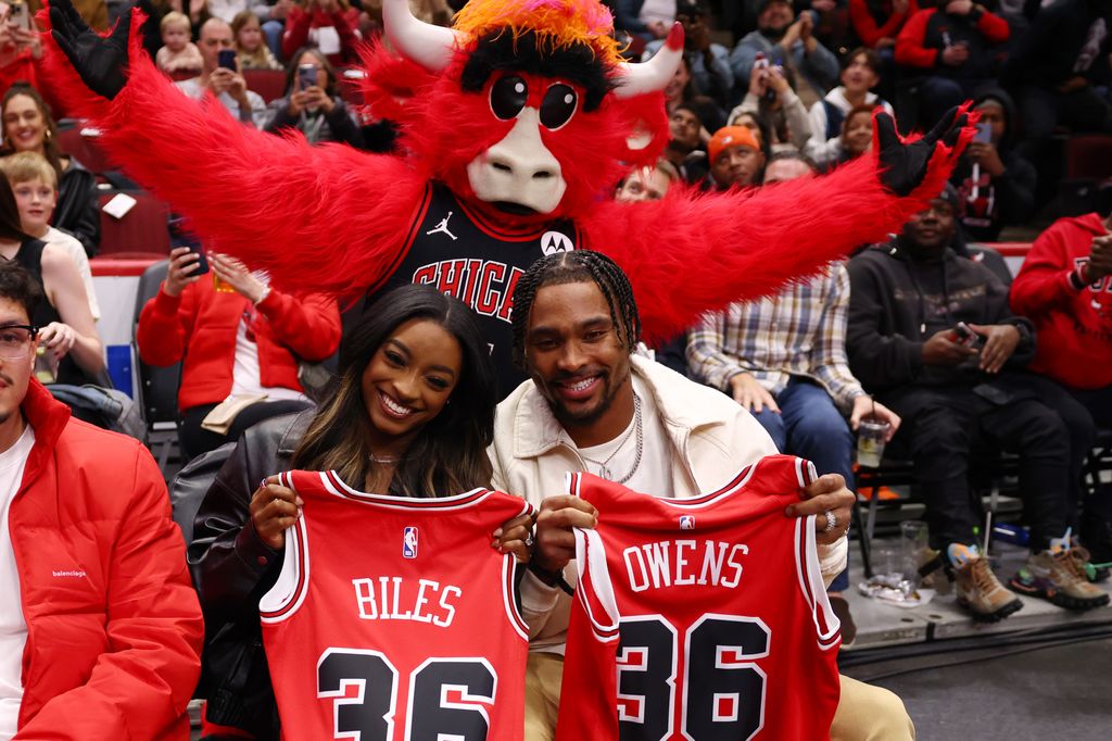 Simone and Jonathan posed with their jerseys