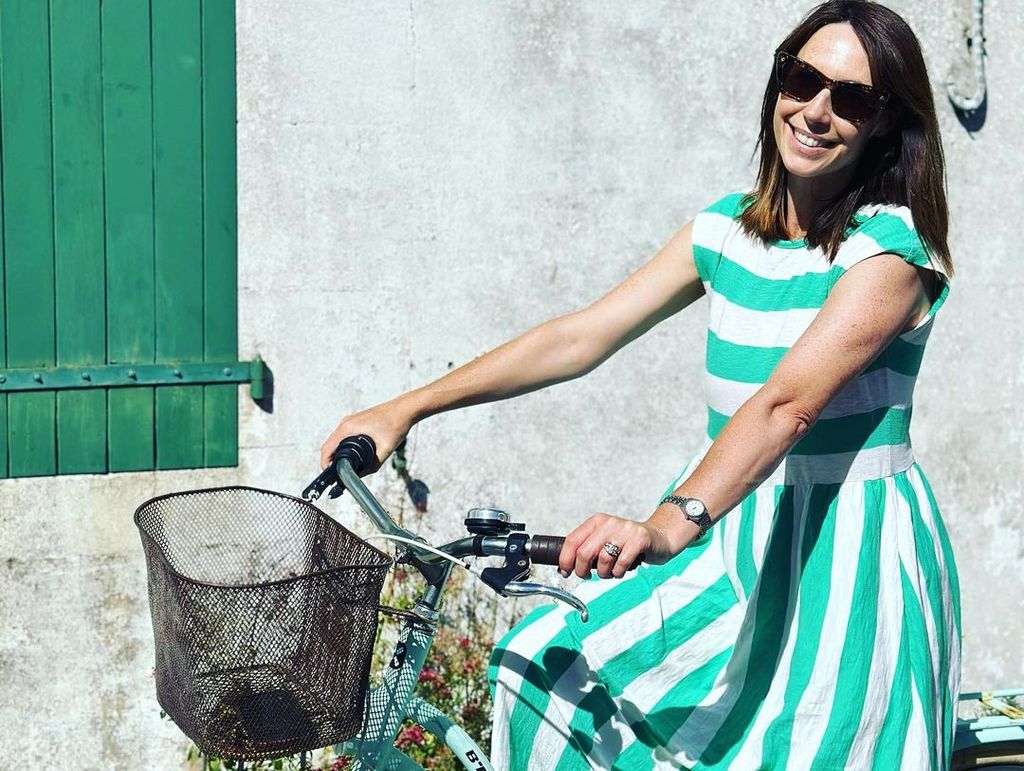 alex jones in bike in striped green dress