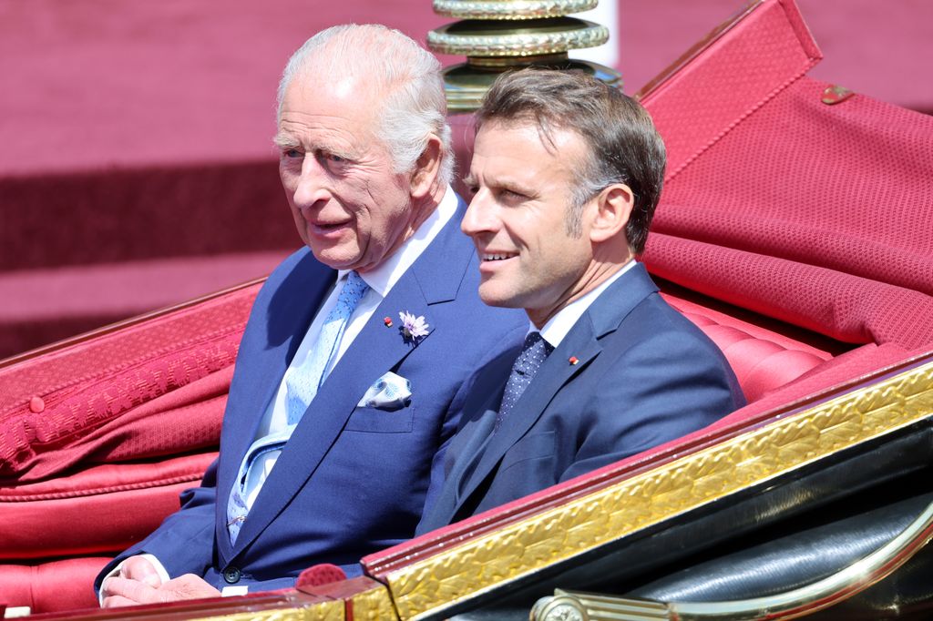 King Charles and Emmanuel Macron riding in a carriage