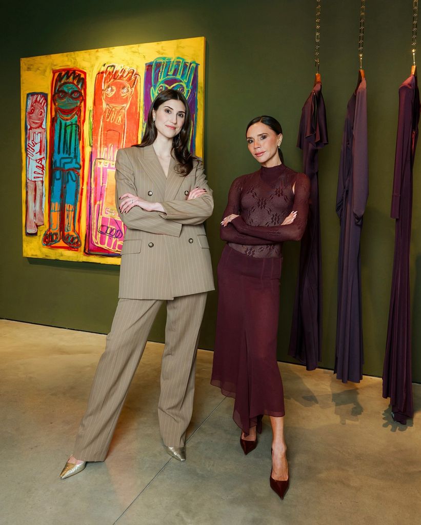 Victoria Beckham and another woman posing in her London store