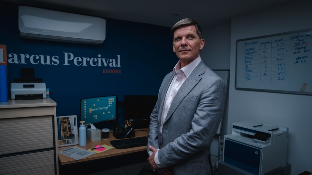 man in suit standing in office