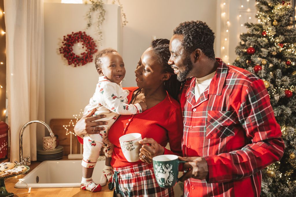 Young family at kitchen on Christmas morning. 