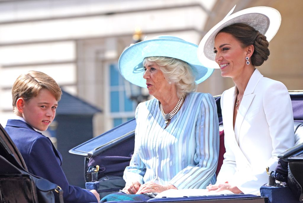 Princess Kate, Queen Camilla and Prince George riding in a ceremonial carriage