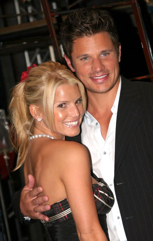 Jessica Simpson and Nick Lachey smiling together at an event