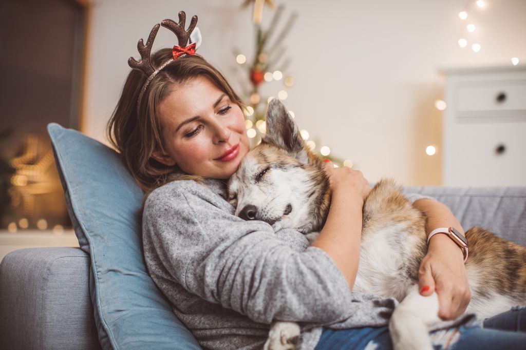  woman celebrating winter holidays with dog