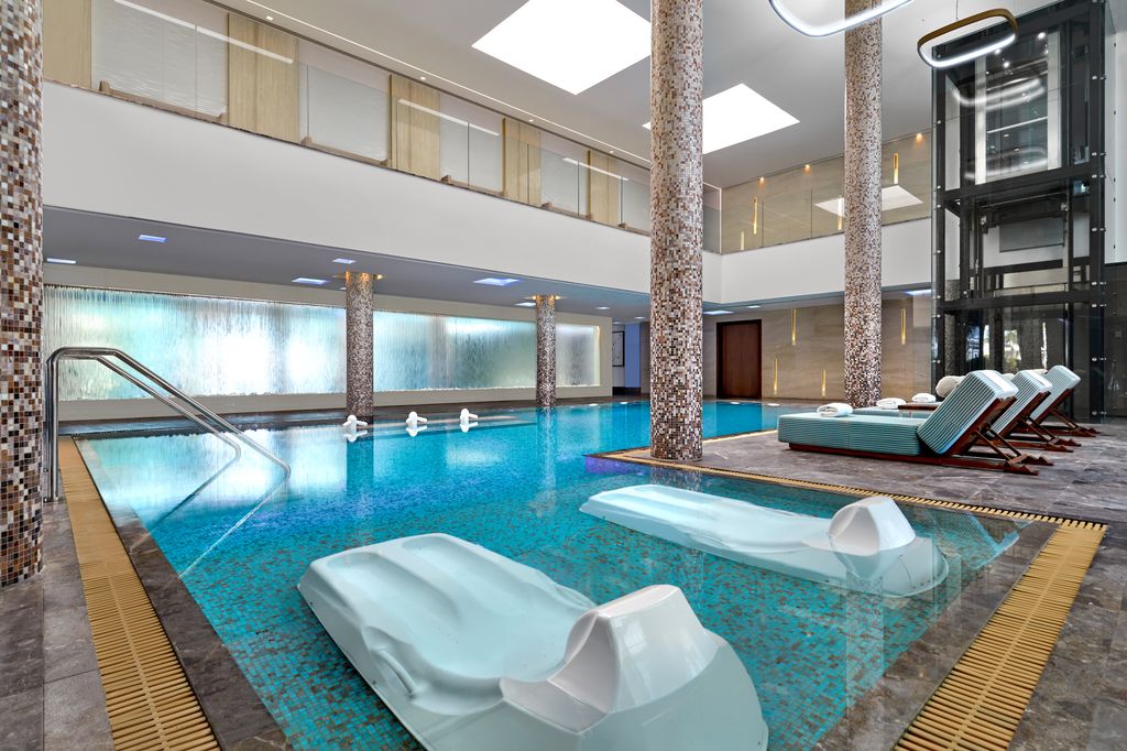 Spa with loungers in the pool and tiles pillars 