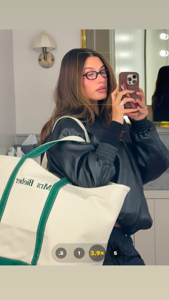 Hailey Bieber carrying a cream and green tote bag 