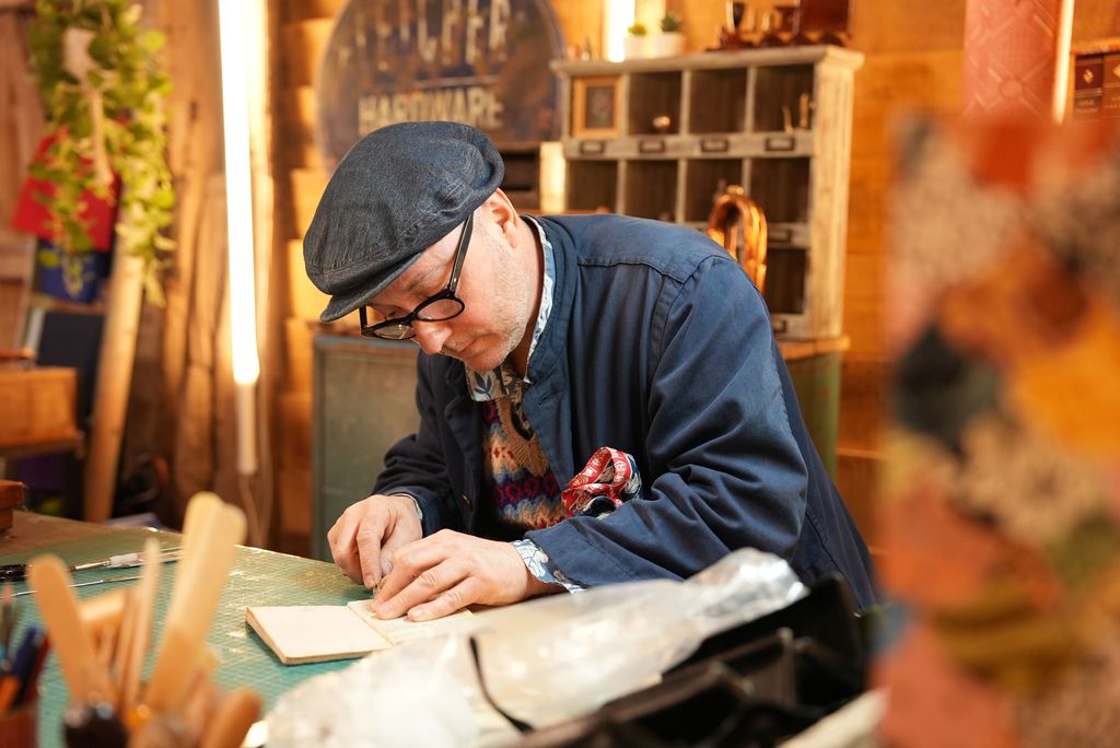 Christopher Shaw repairs book in Repair Shop barn