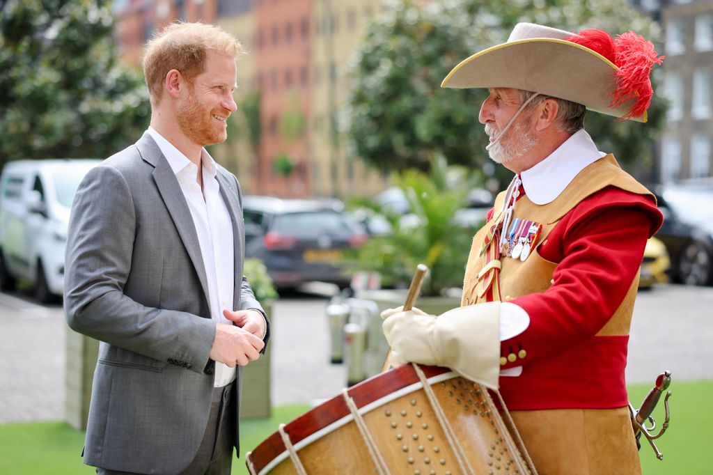 Prince Harry speaking with a drummer