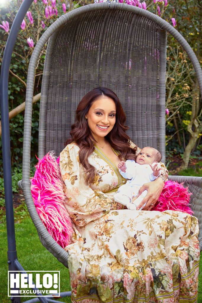 Seema Jaswal cradles her newborn baby as she sits in garden swing chair