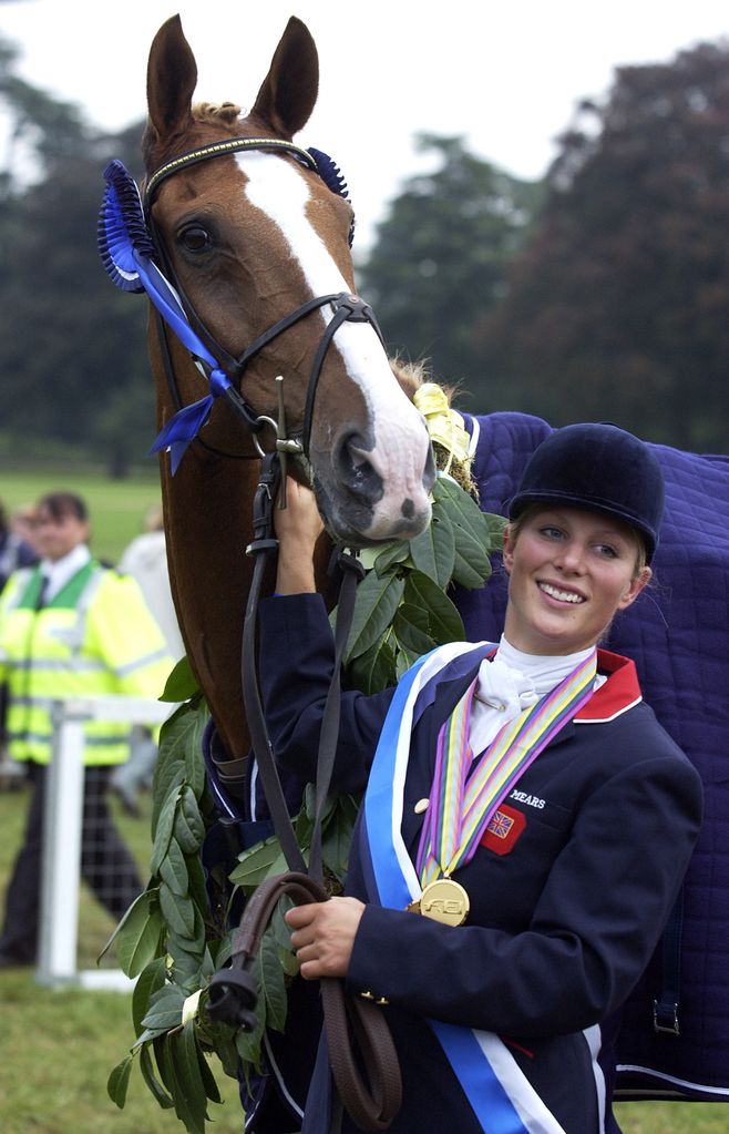 Zara wears her gold medal and poses with her horse Toytown after becoming European Champion at the European Eventing Championships 