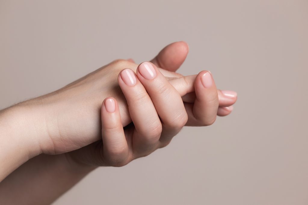 Hands with beautiful manicure - pink gel nails