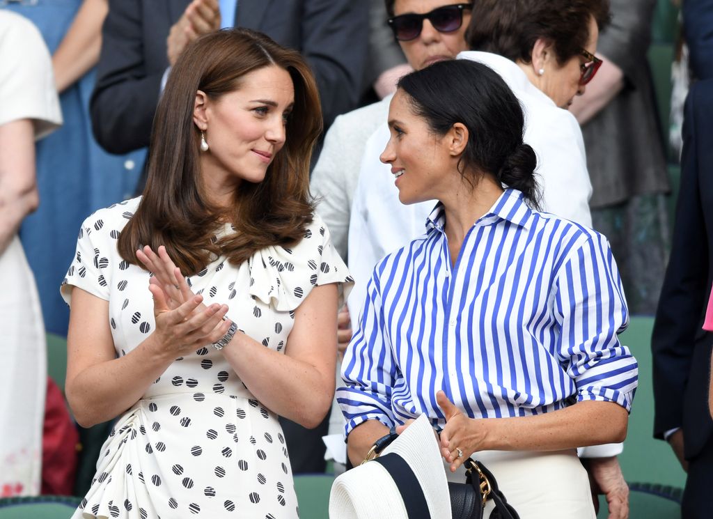 Catherine, Duchess of Cambridge and Meghan, Duchess of Sussex attend day twelve of the Wimbledon Tennis Championships at the All England Lawn Tennis and Croquet Club on July 14, 2018 in London, England. 