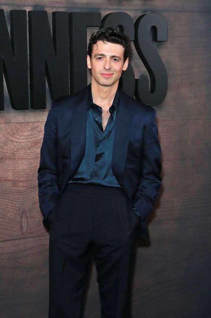 Anthony Boyle posed in navy shirt and blazer