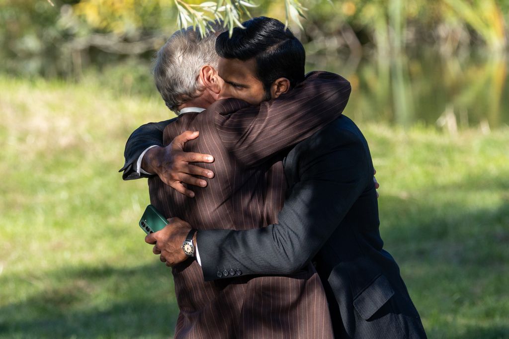 two men hugging in meadow