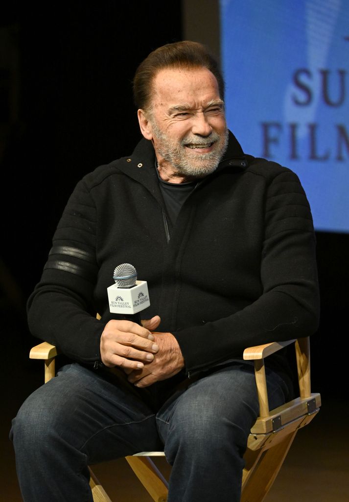 Arnold Schwarzenegger in jeans and black jumper at the 2025 Sun Valley Film Festival