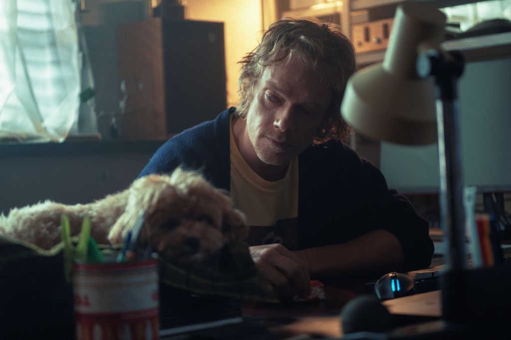 man sitting at desk with dog
