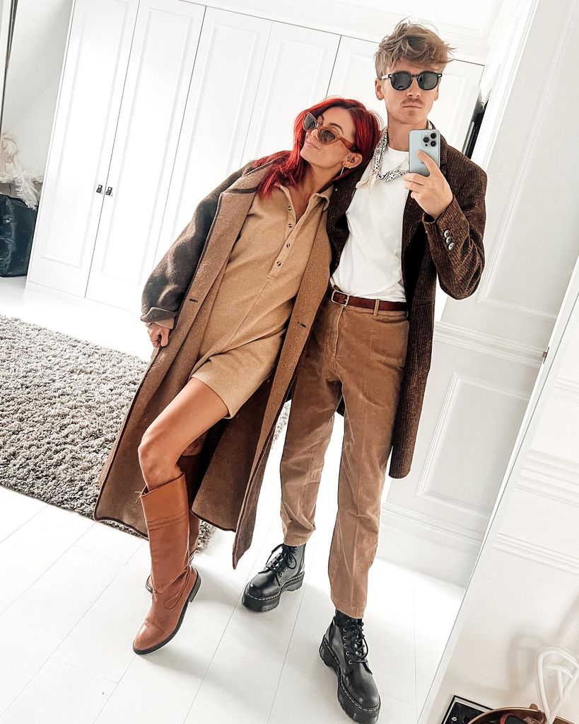 Dianne Buswell and Joe Sugg posing in front of a mirror in matching clothes