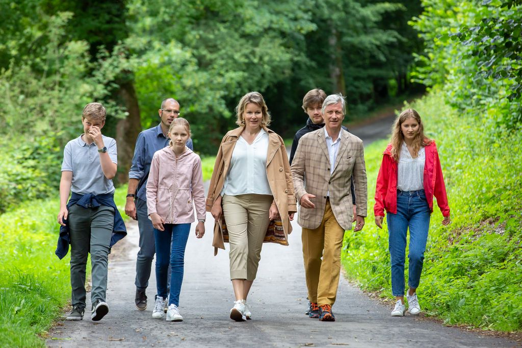 Queen Mathilde and King Philippe walking with their children