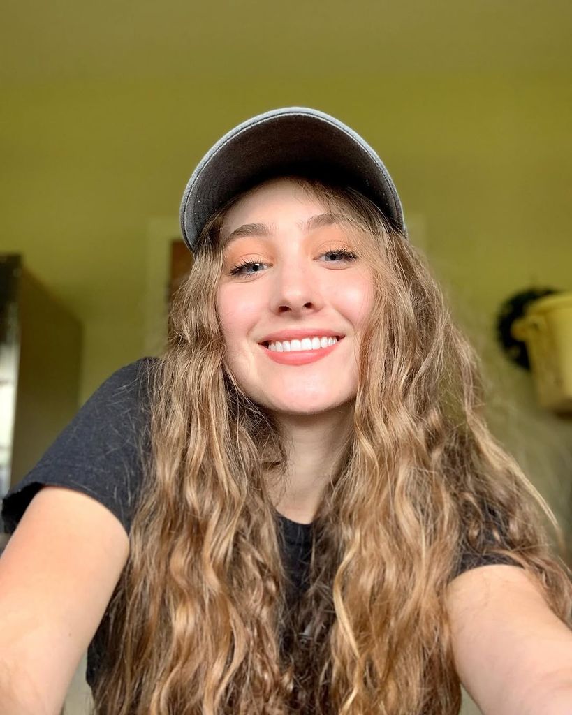 Chappell Roan wearing a cap taking selfie in her bedroom at home