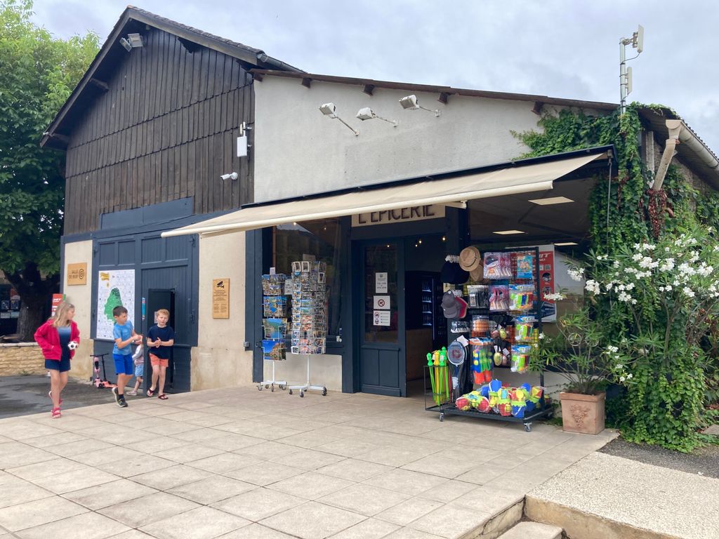 Facade of shop with people walking by on the patio