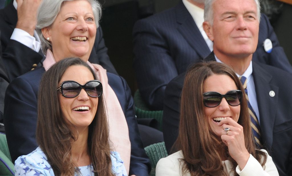 Catherine, Duchess of Cambridge and her sister Pippa Middleton (L) react while watching the action from the Royal Box of the men's singles final match between Britain's Andy Murray and Switzerland's Roger Federer on Centre Court on day 13 of the 2012 Wimb