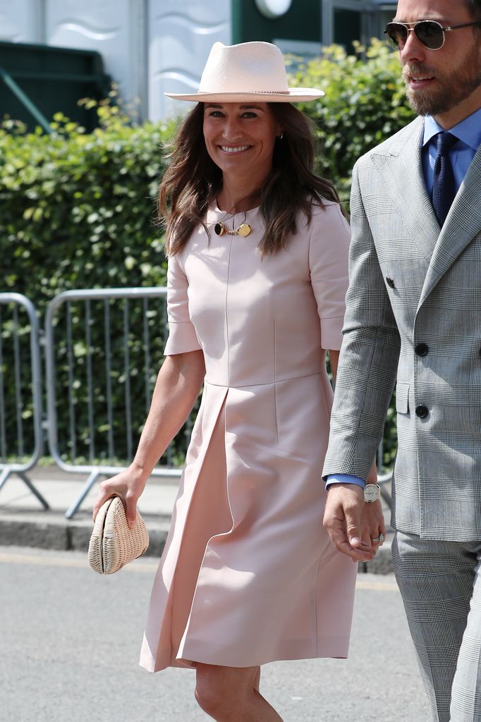 Pippa Middleton wearing a pink dress with brother James at Wimbledon in 2019