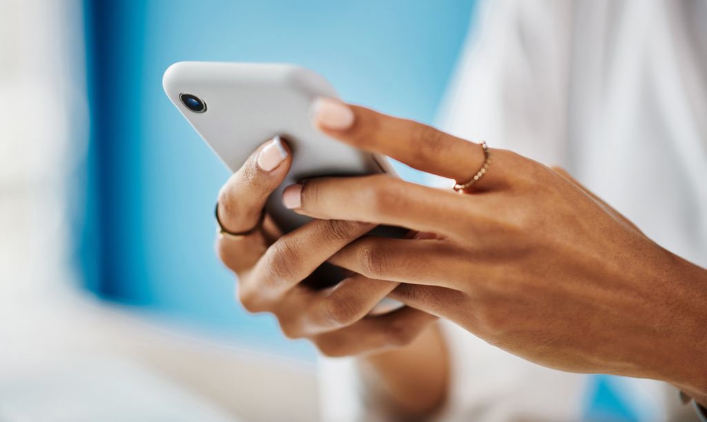 Studio shot of an woman checking her phone