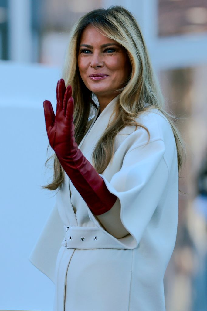 Melania Trump in cream coat and red gloves