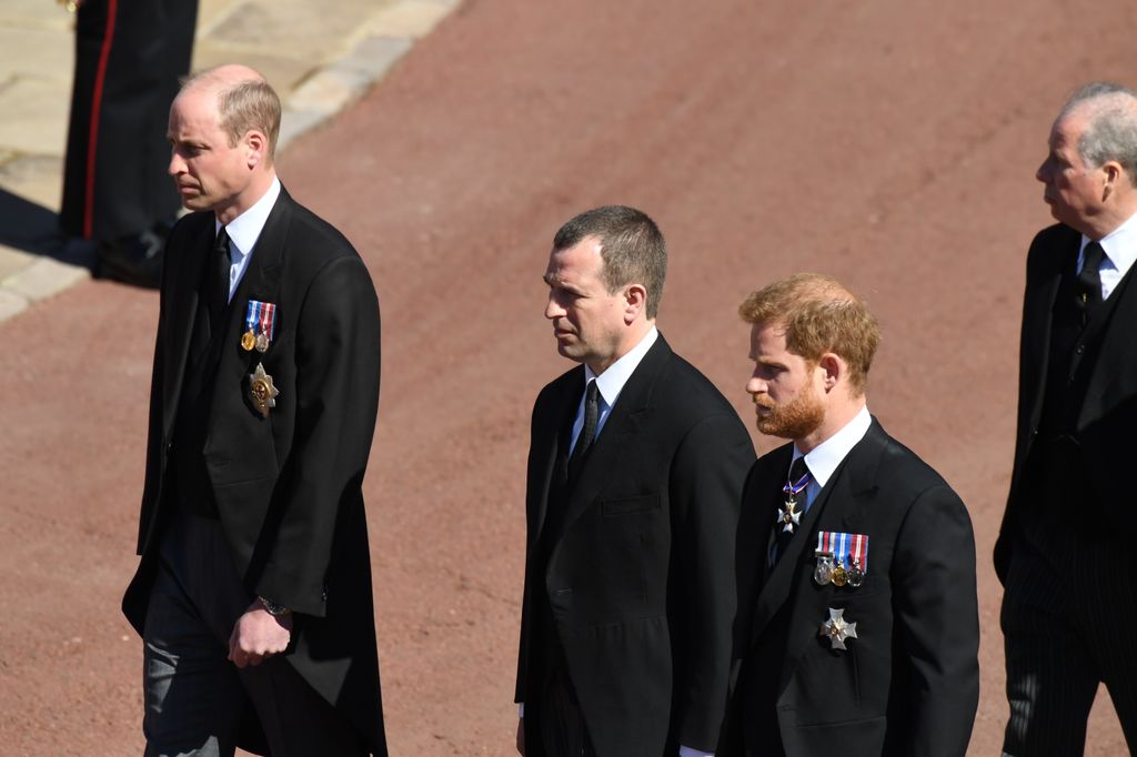 Peter Phillips stands between Prince William and Prince Harry during the funeral procession for their grandfather Prince Philip in Windsor Castle on April 17, 2021