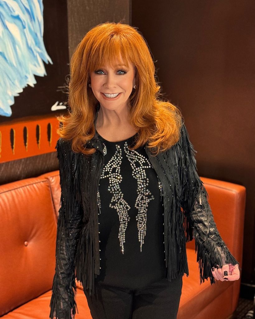 reba mcentire wearing all black smiling at camera