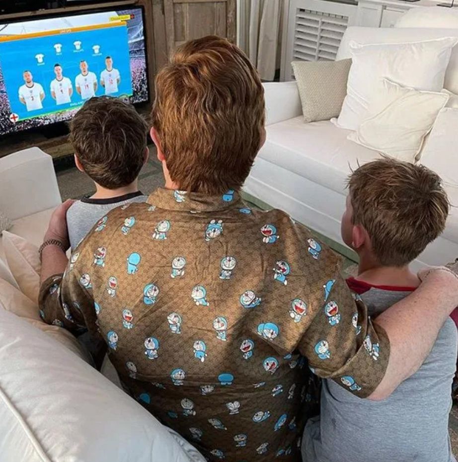 Elton John and his two sons watching football