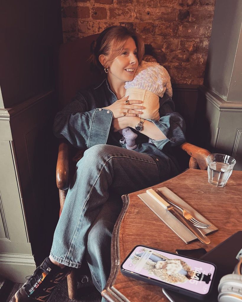 Stacey Dooley's baby daughter lay over her shoulder as she enjoyed dinner