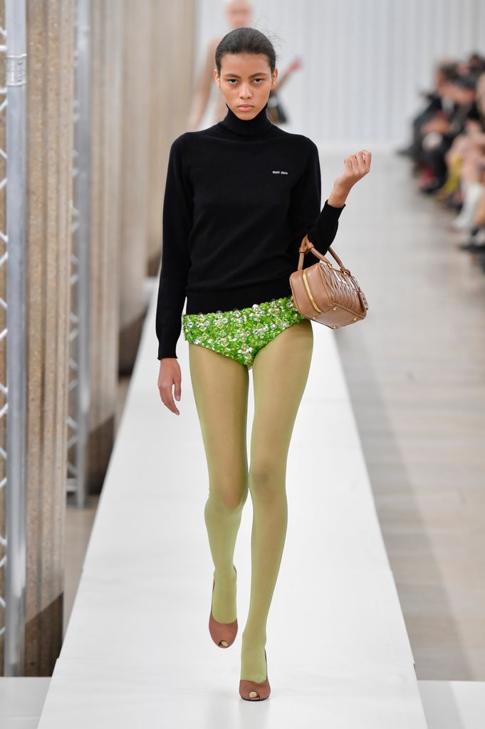 Miu Miu model in green tights and green pants