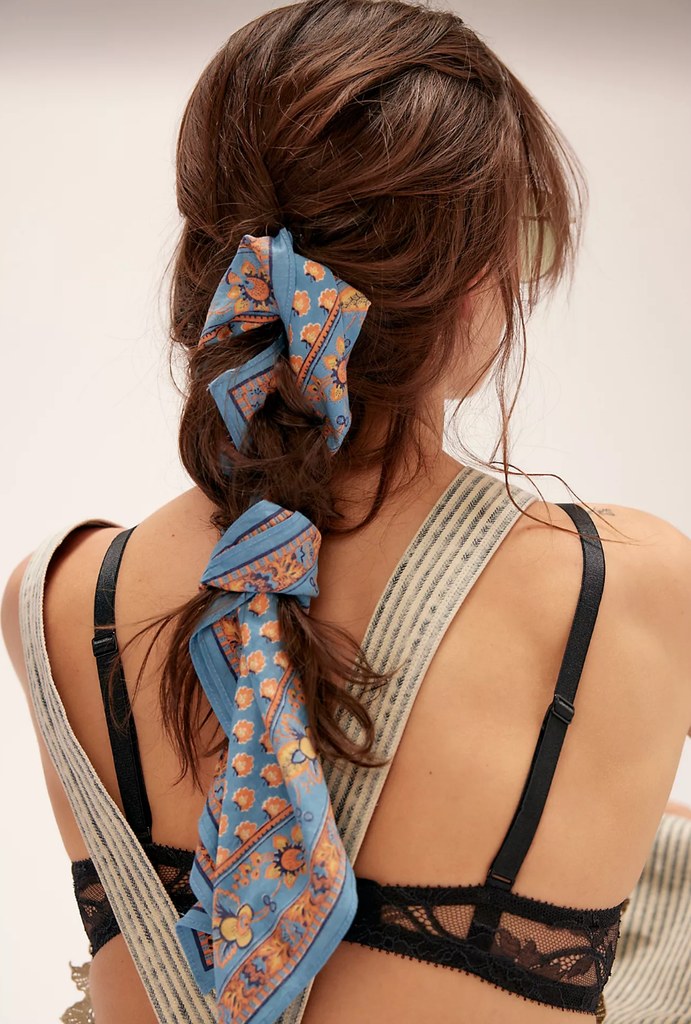 A model wears a scarf in her braid