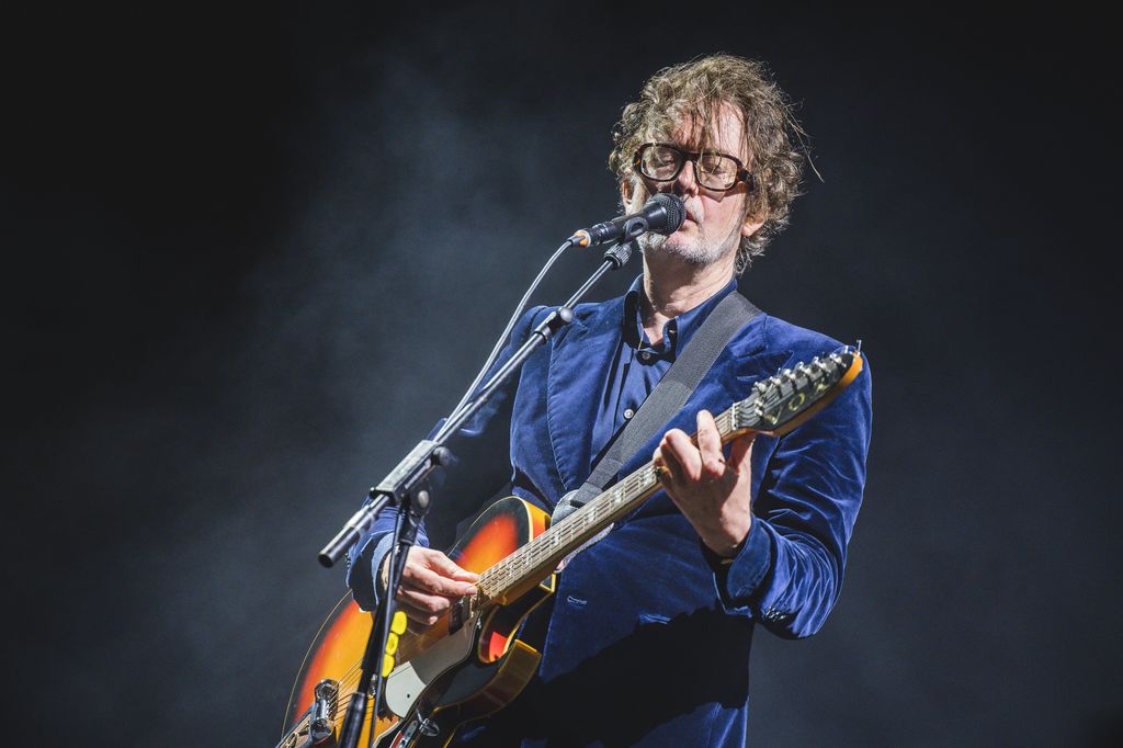 Jarvis Cocker performing with a guitar