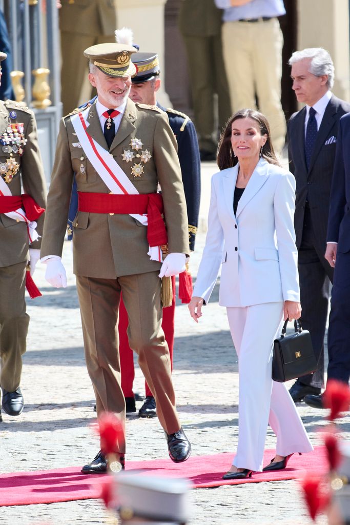 King Felipe in military uniform and Queen Letizia in blue suit