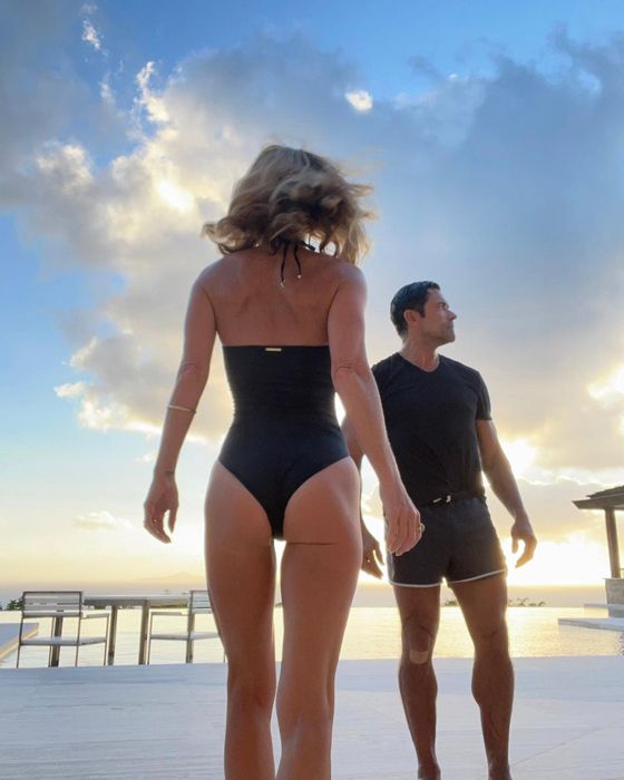 Kelly ripa and Mark Consuelos on the beach with kelly wearing a thong 