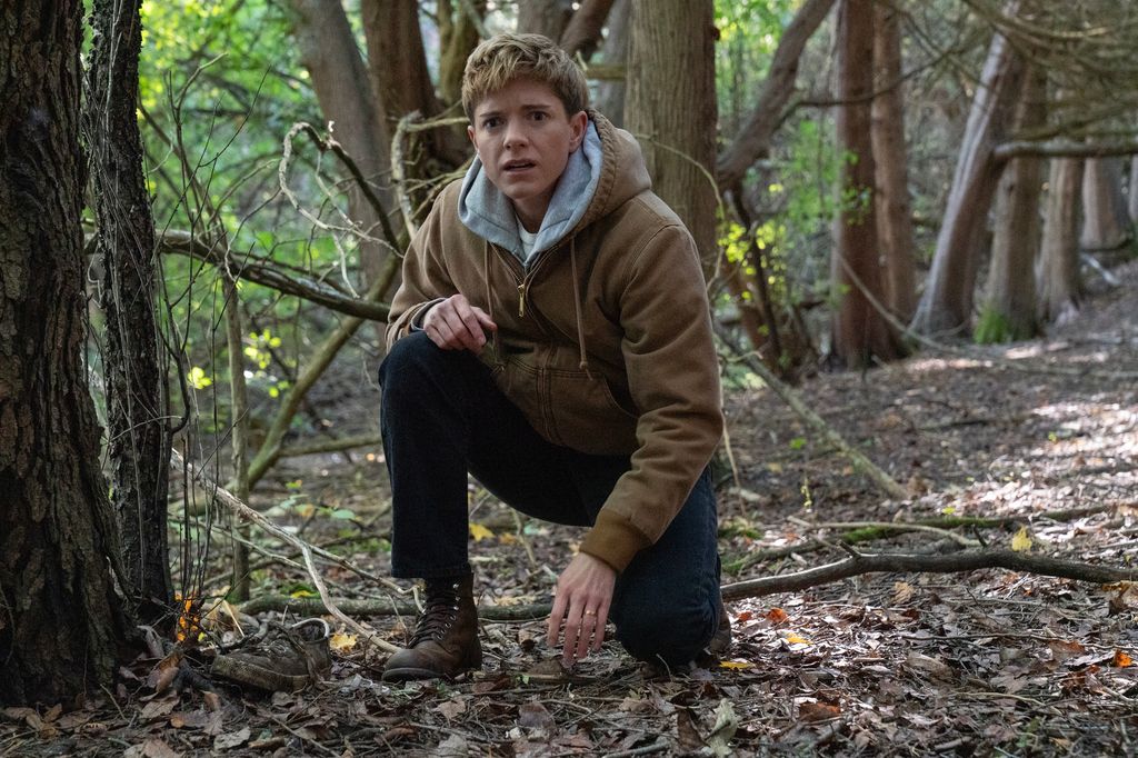 person in woodland area crouching down