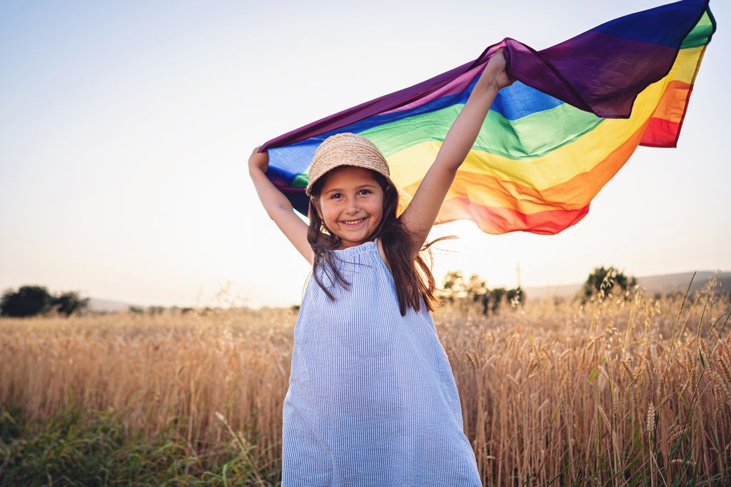 Girl holds the LGBTQ flag