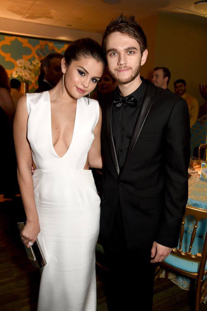 Selena posing for a photo with Zedd 