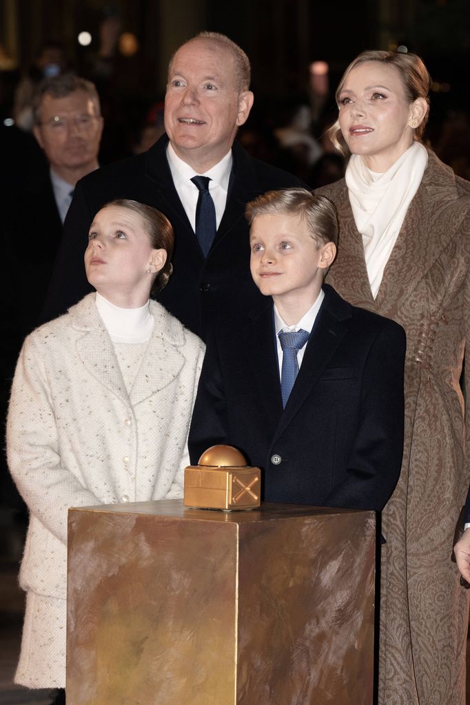 princely family in coats looking into sky