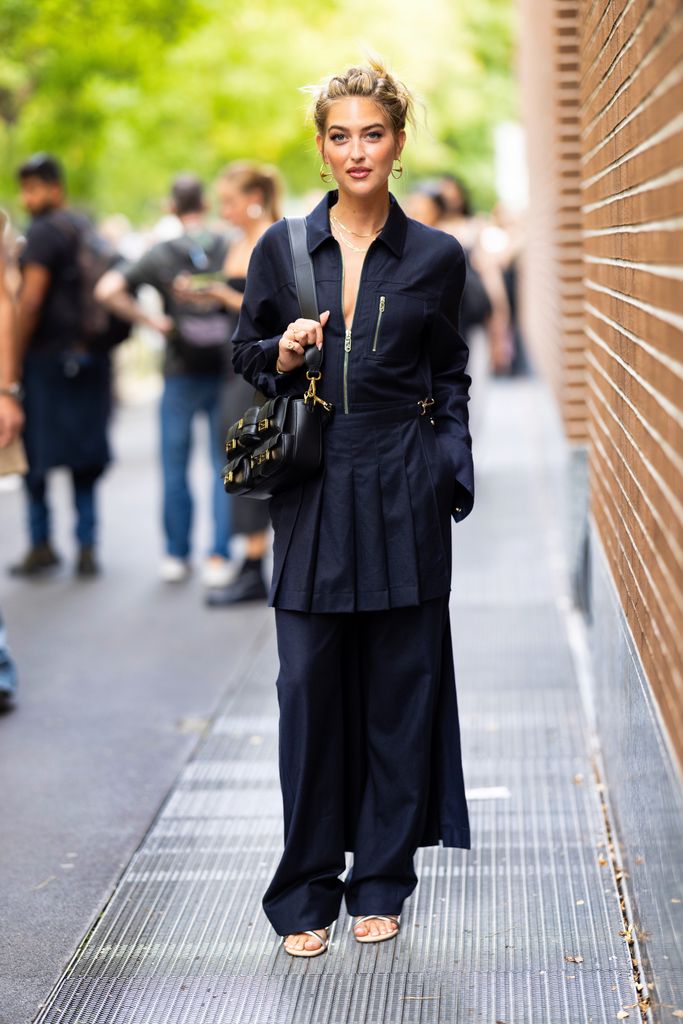 MILAN, ITALY - SEPTEMBER 20: Emili Sindlev is seen wearing hoop gold earrings, a blue Fendi tracksuit and a black leather Fendi baguette outside Fendi show during the Milan Fashion Week - Womenswear Spring/Summer 2024 on September 20, 2023 in Milan, Italy. (Photo by Valentina Frugiuele/Getty Images)