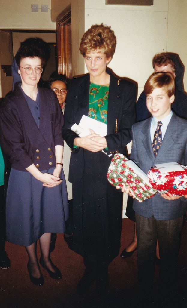 William holding xmas presents at the Passage with Diana in 1992