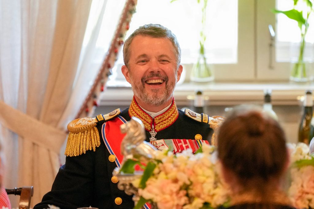 King Frederik laughing at gala dinner