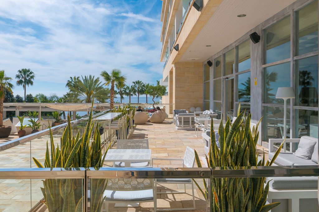 Exterior terrace at luxury spanish hotel with blue sky and ocean in the background
