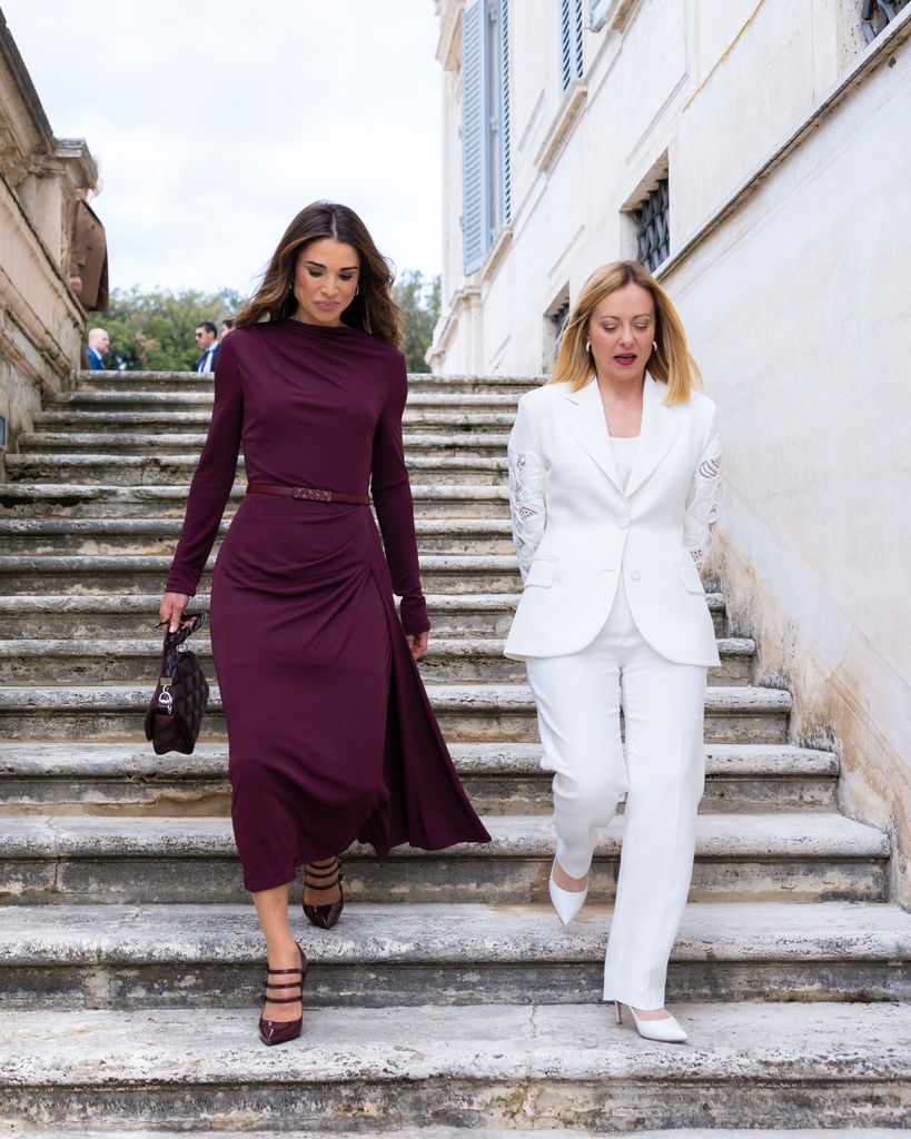 two women walking down steps in rome 