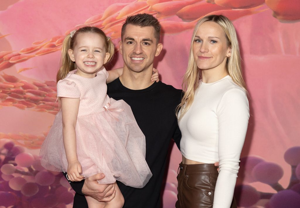 family of three posing at cinema screening