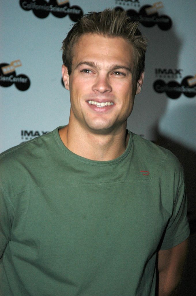 George Stults spiky hair, t-shirt, smiling
